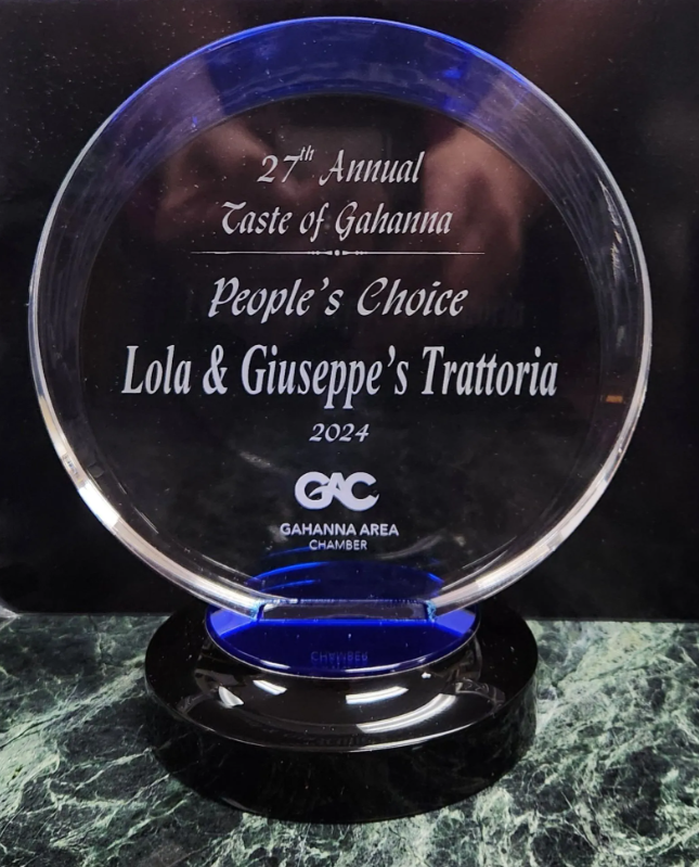 Laser cutter cutting shapes from metal sheet. Sparks fly from the cutting point in an industrial setting.