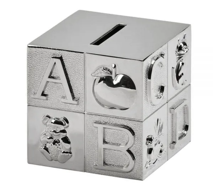 Dog tags on a ball chain, engraved with military information, lying against a cork background.