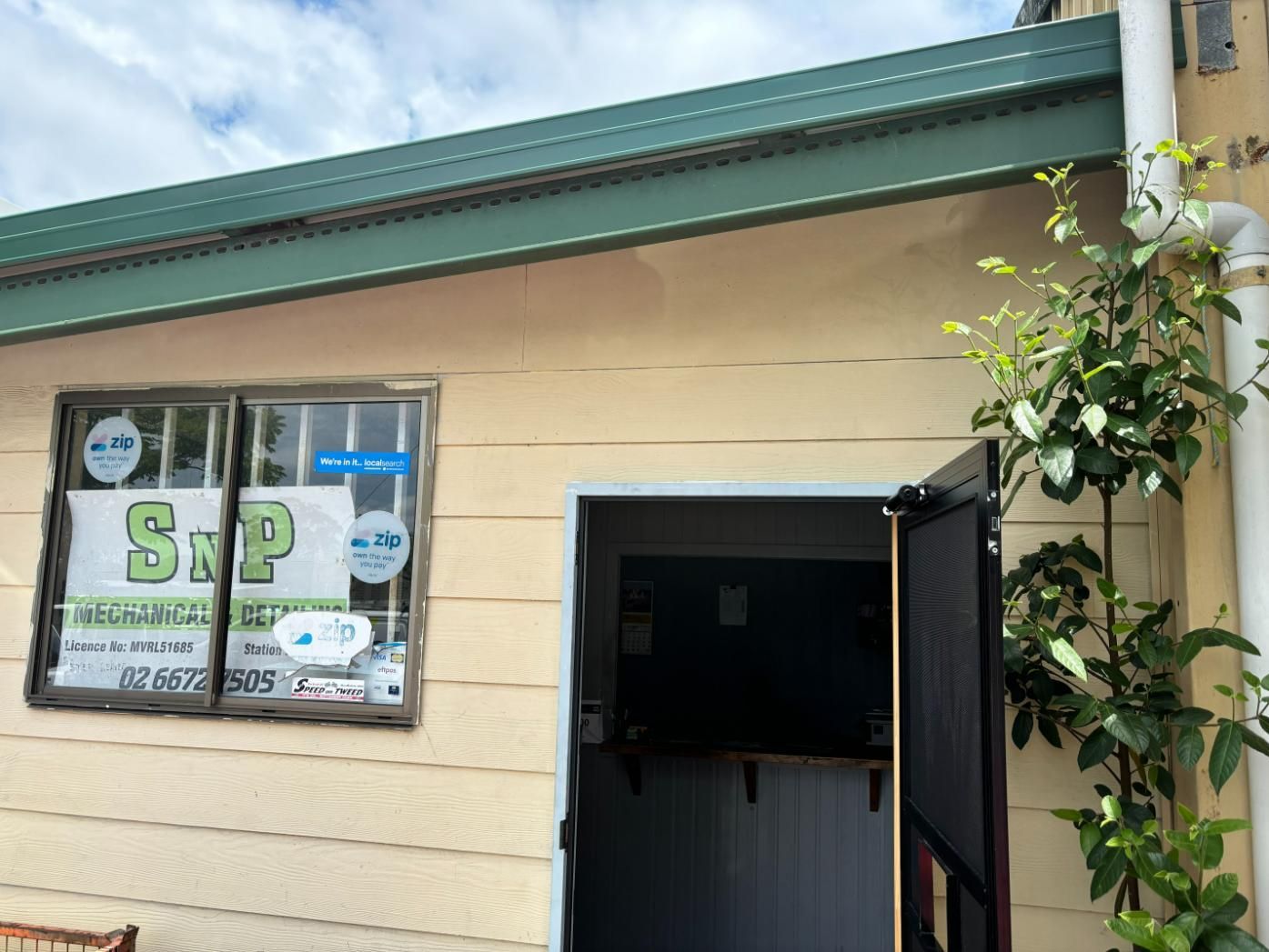 A Building With A Sign On The Window — SnP Mechanical & Detailing In Murwillumbah, NSW