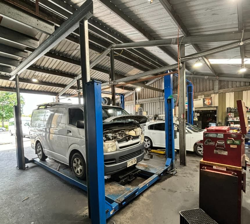 A Van Is Sitting On A Lift In A Garage — SnP Mechanical & Detailing In Murwillumbah, NSW