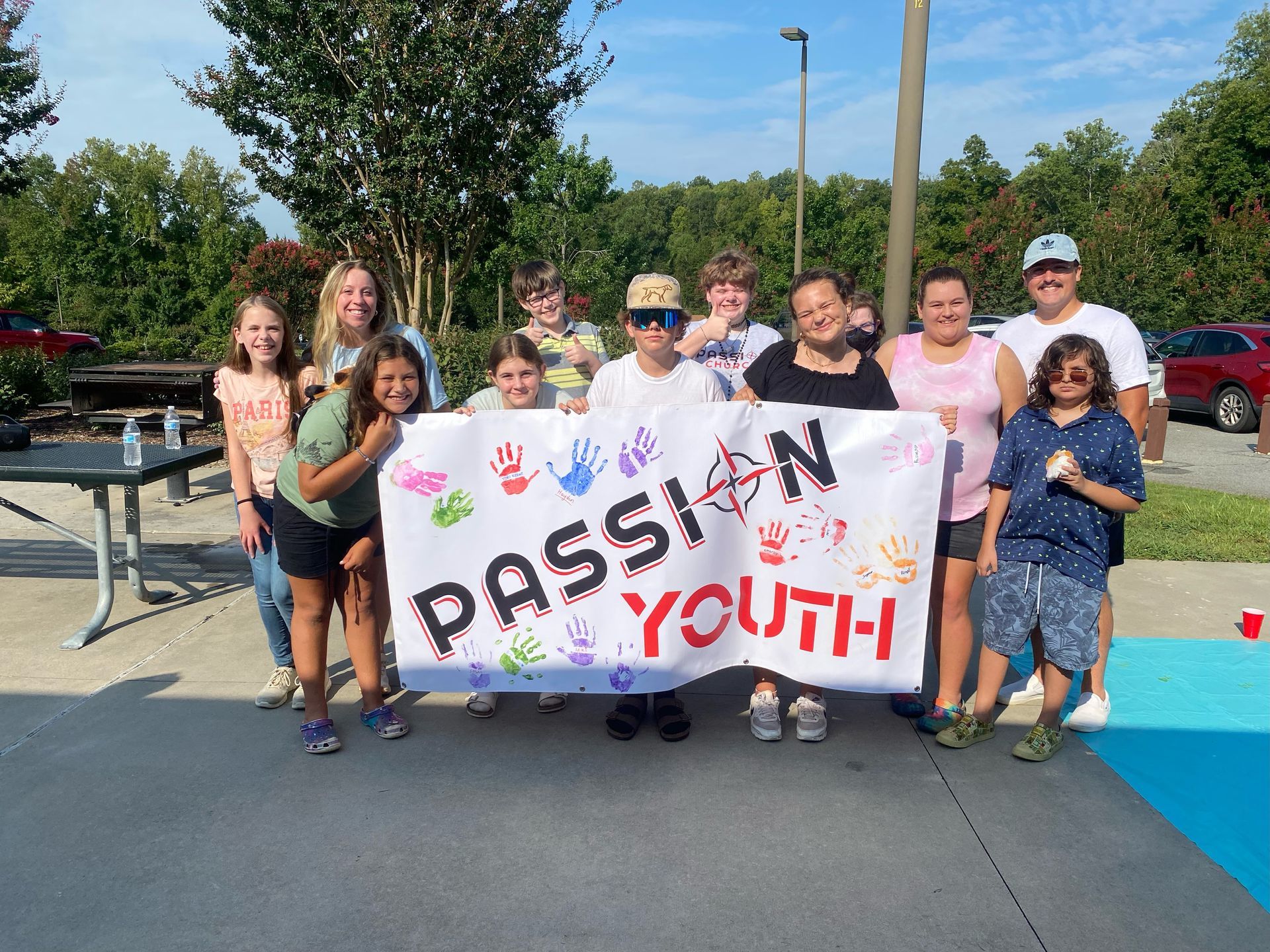 A group of people holding a sign that says passion youth