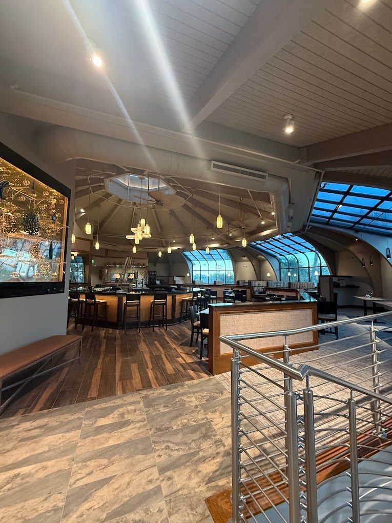 A large room with a staircase leading to the second floor