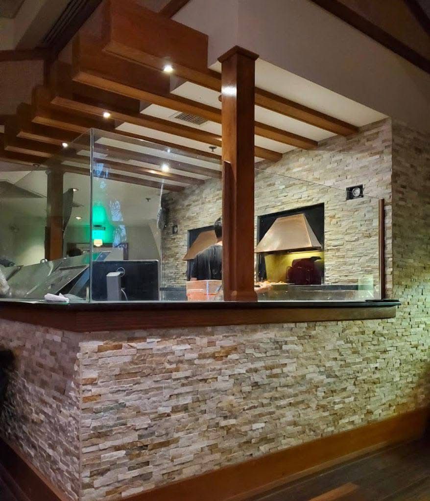 A restaurant with a brick wall and wooden beams