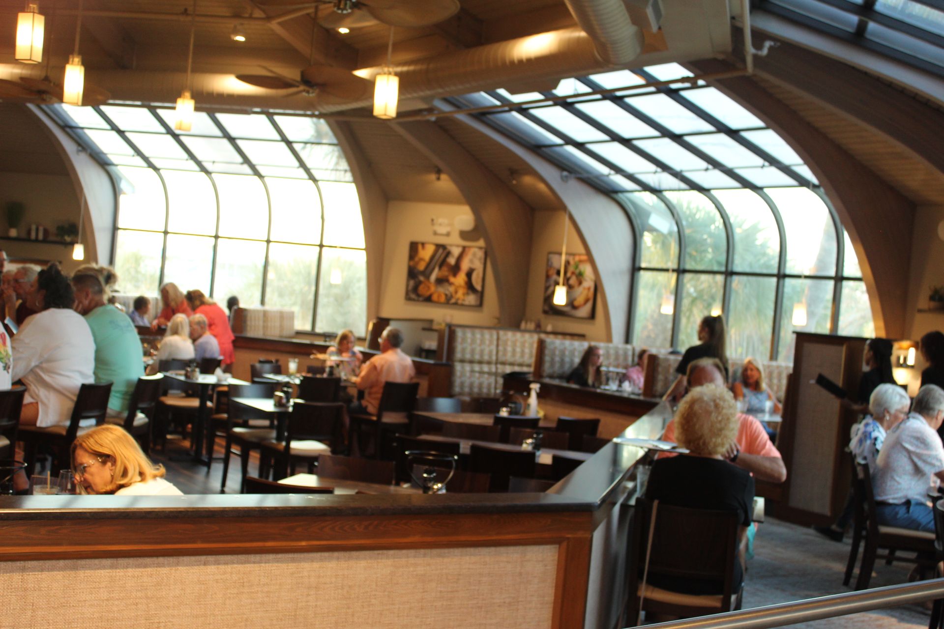 A group of people are sitting at tables in a restaurant