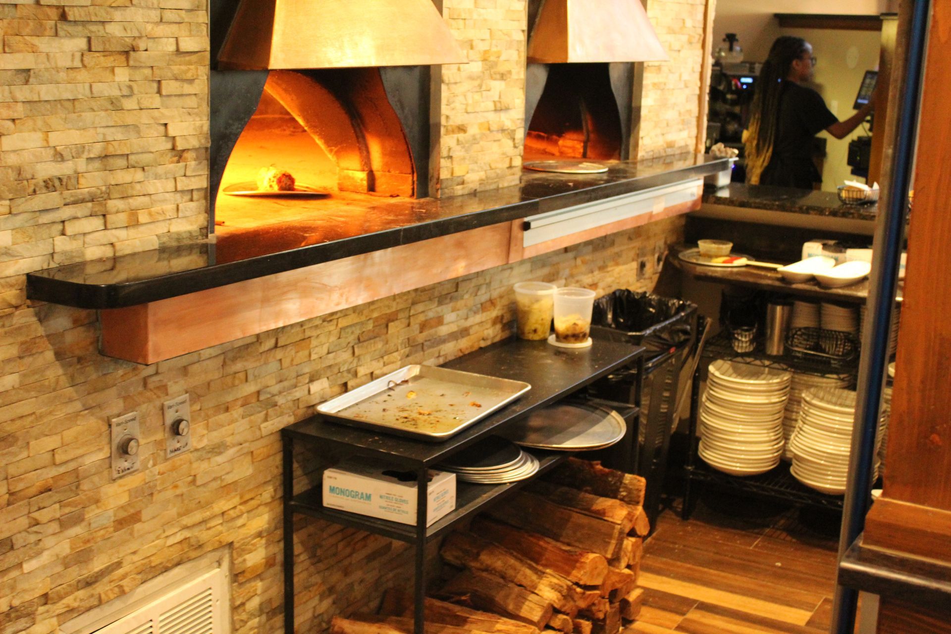 A pizza oven is being used in a restaurant.