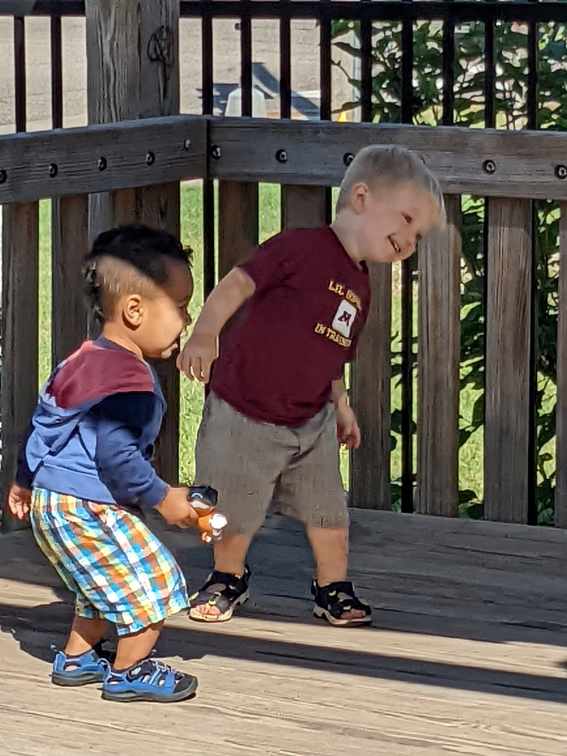 Two young boys are standing next to each other