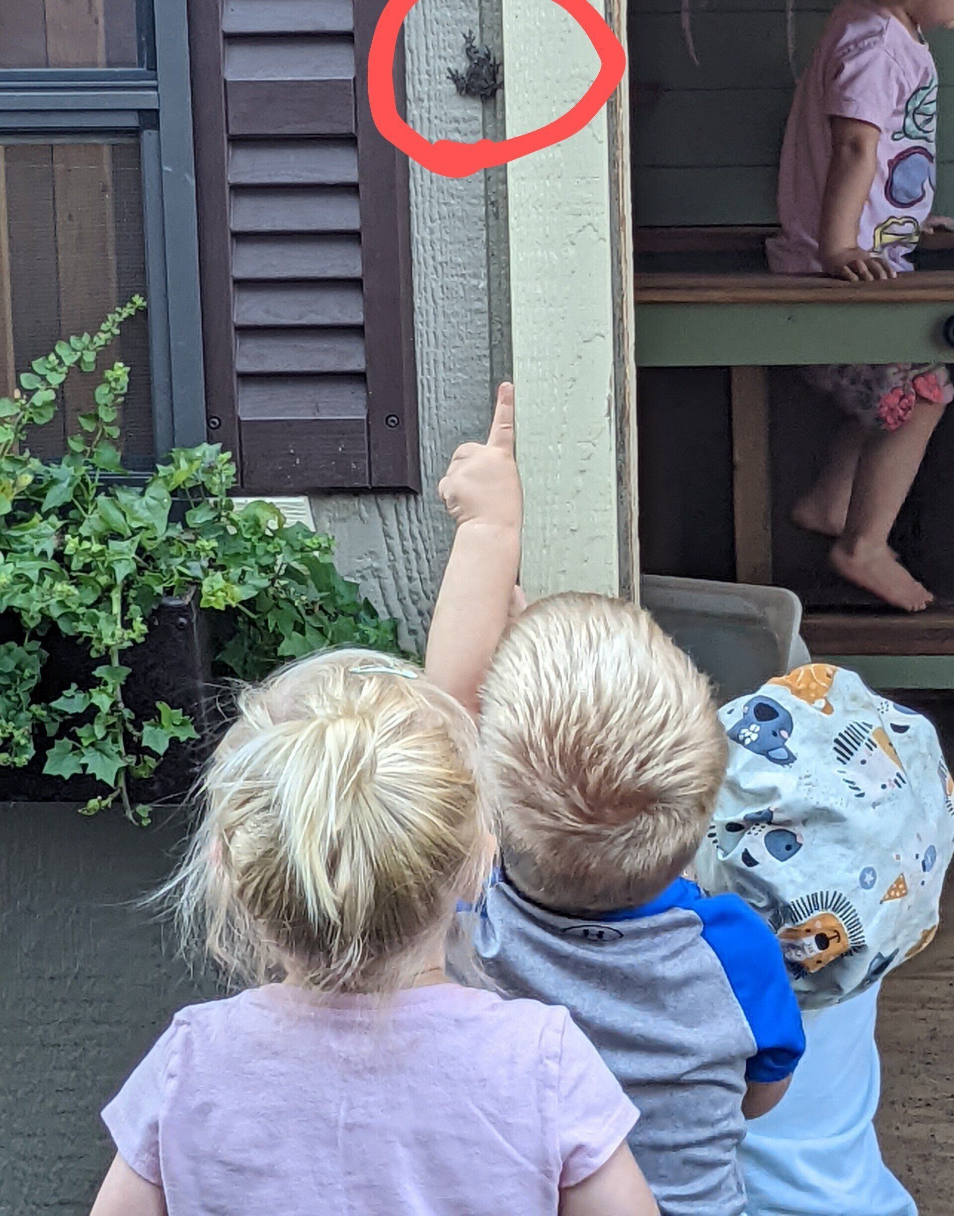 A boy and a girl are looking at a door 
