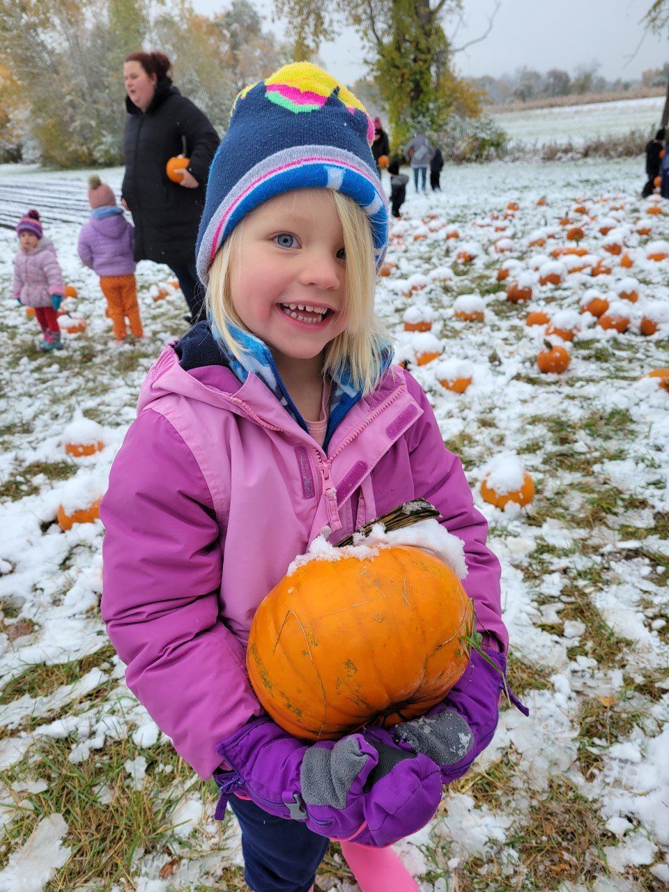 A little girl in a pink jacket 