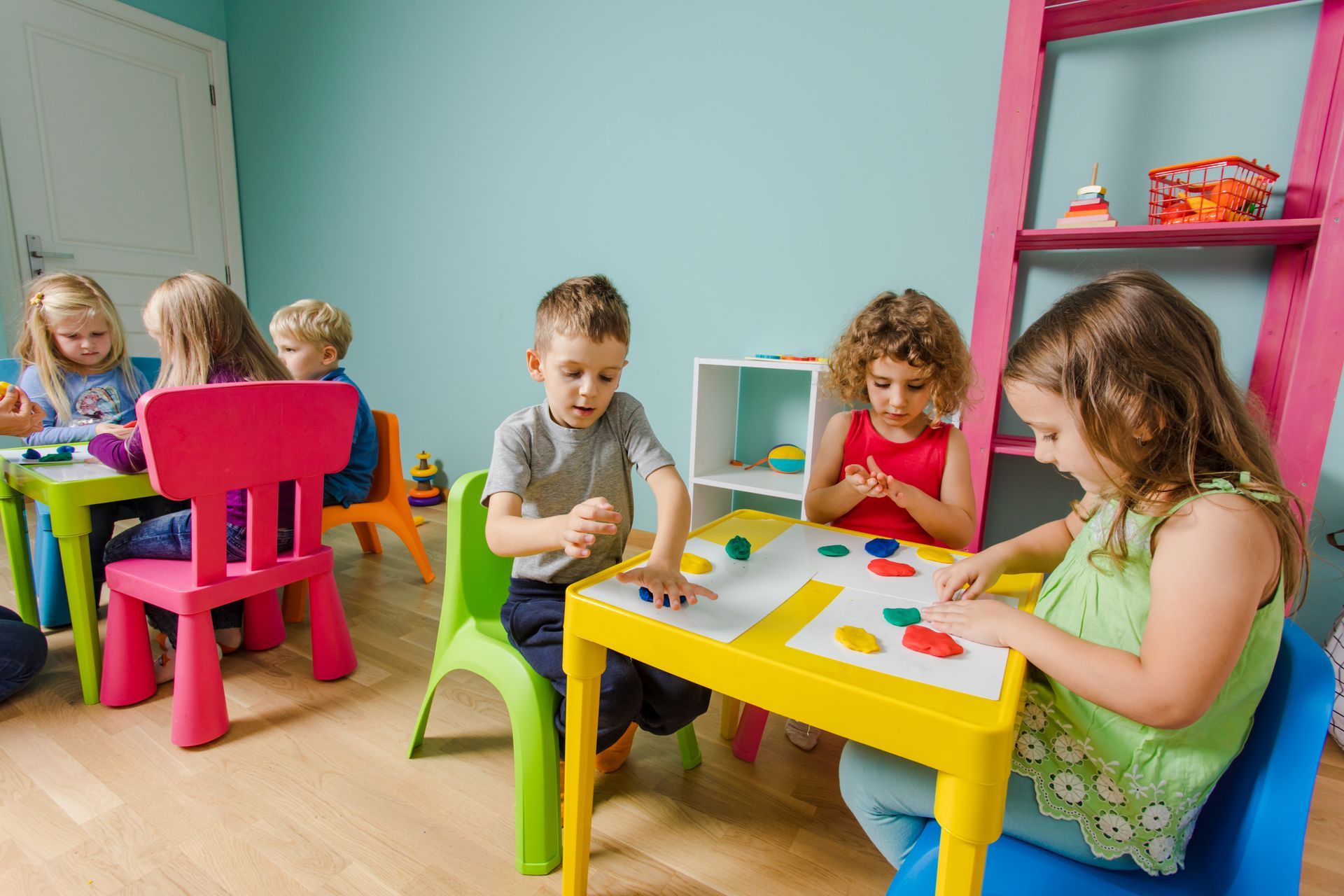 Children are sitting at tables in a room