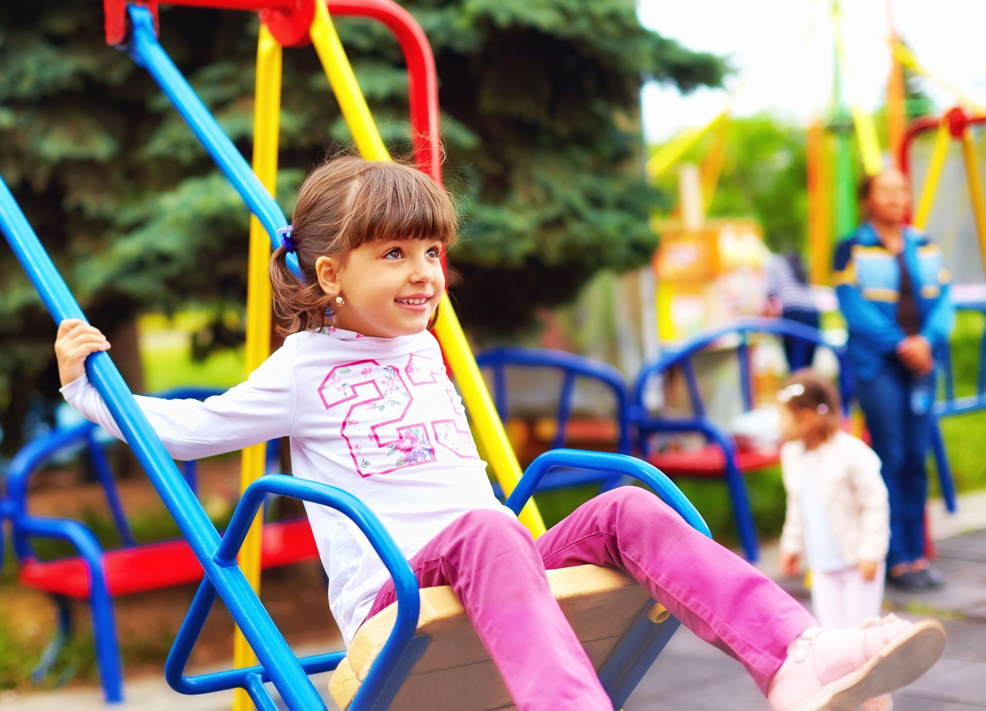 Girl is sitting on a swing