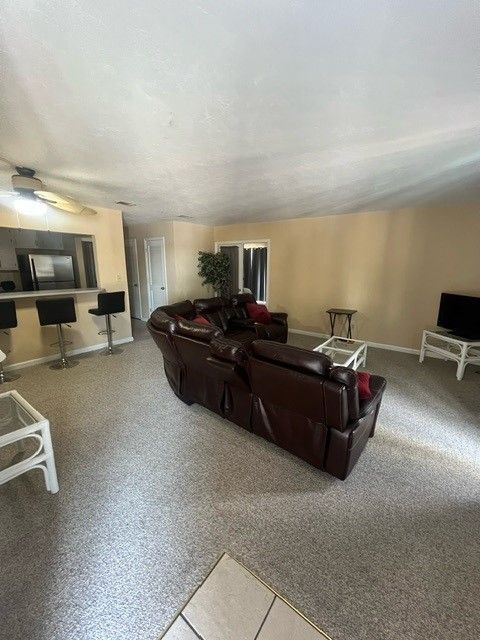 A living room with a brown couch and a television