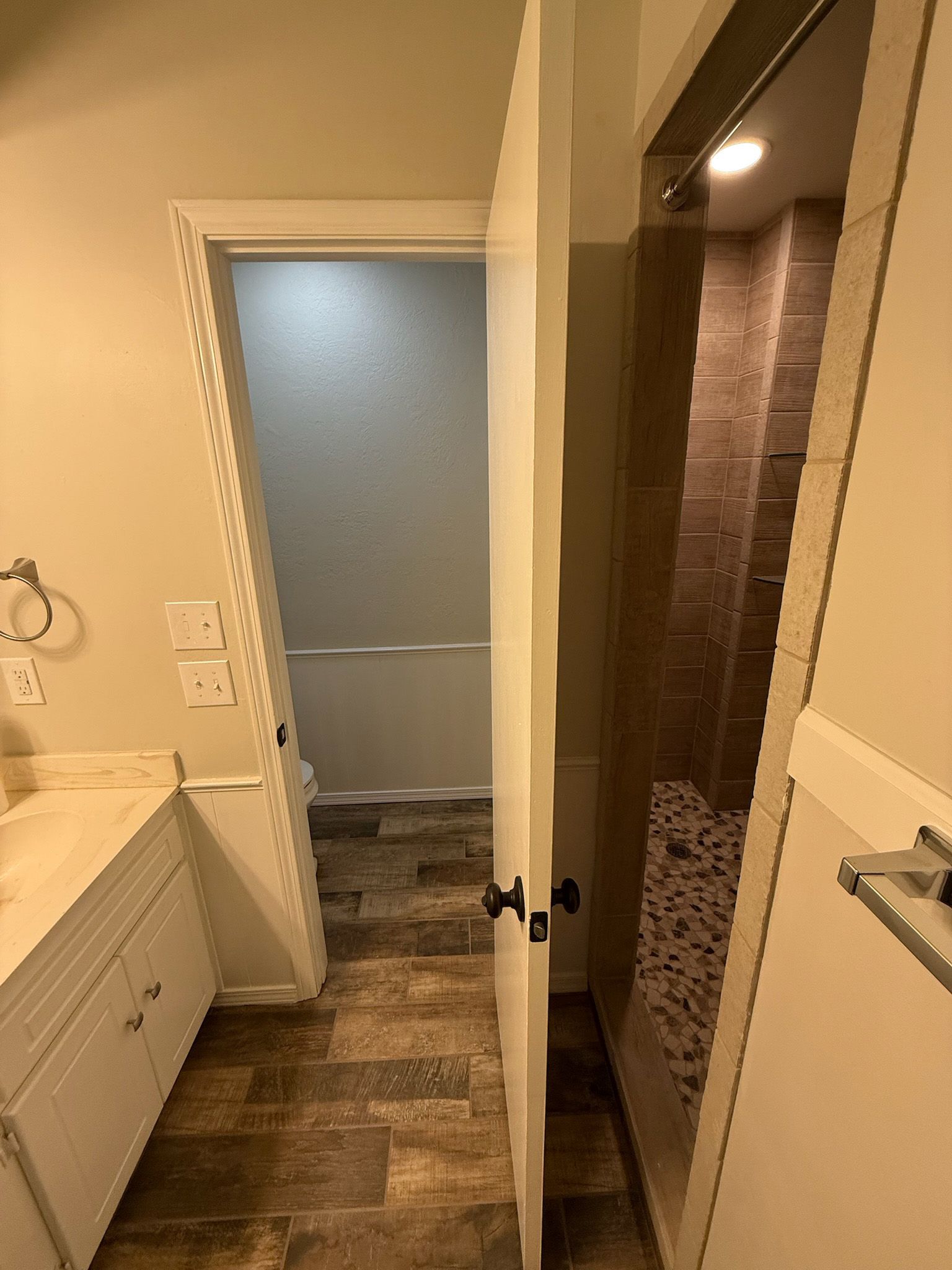 Bathroom doorway with a shower on the right and a tub behind the door on the left.