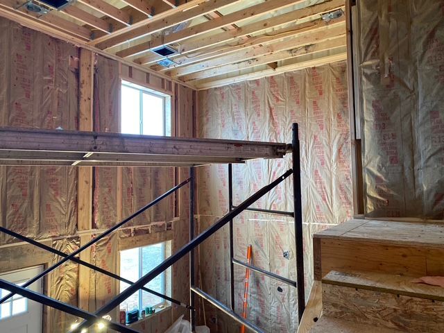 Interior construction: Walls with insulation, scaffolding, window.