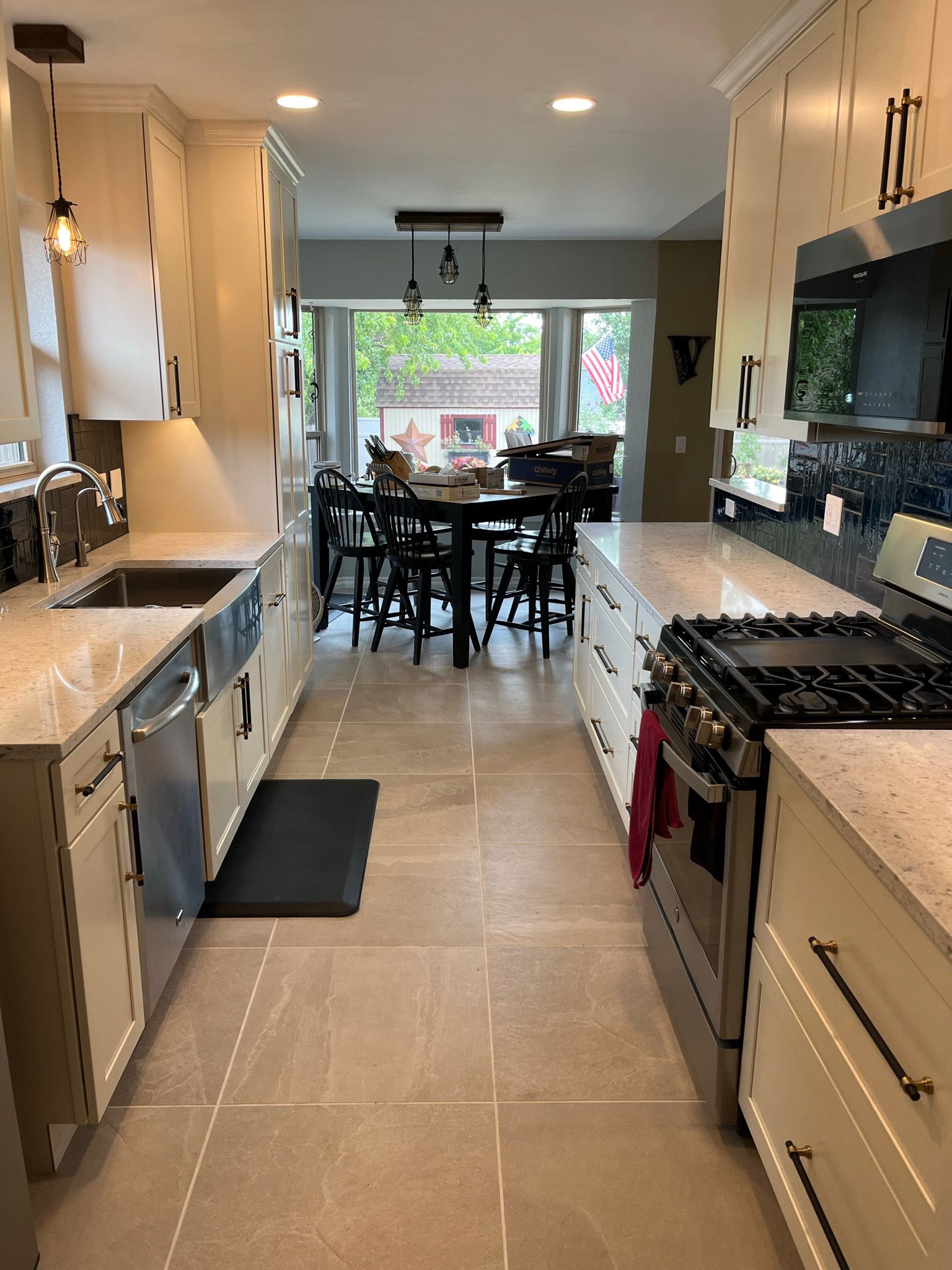 Kitchen with light cabinets, stainless steel appliances, and a dining area visible in the background.