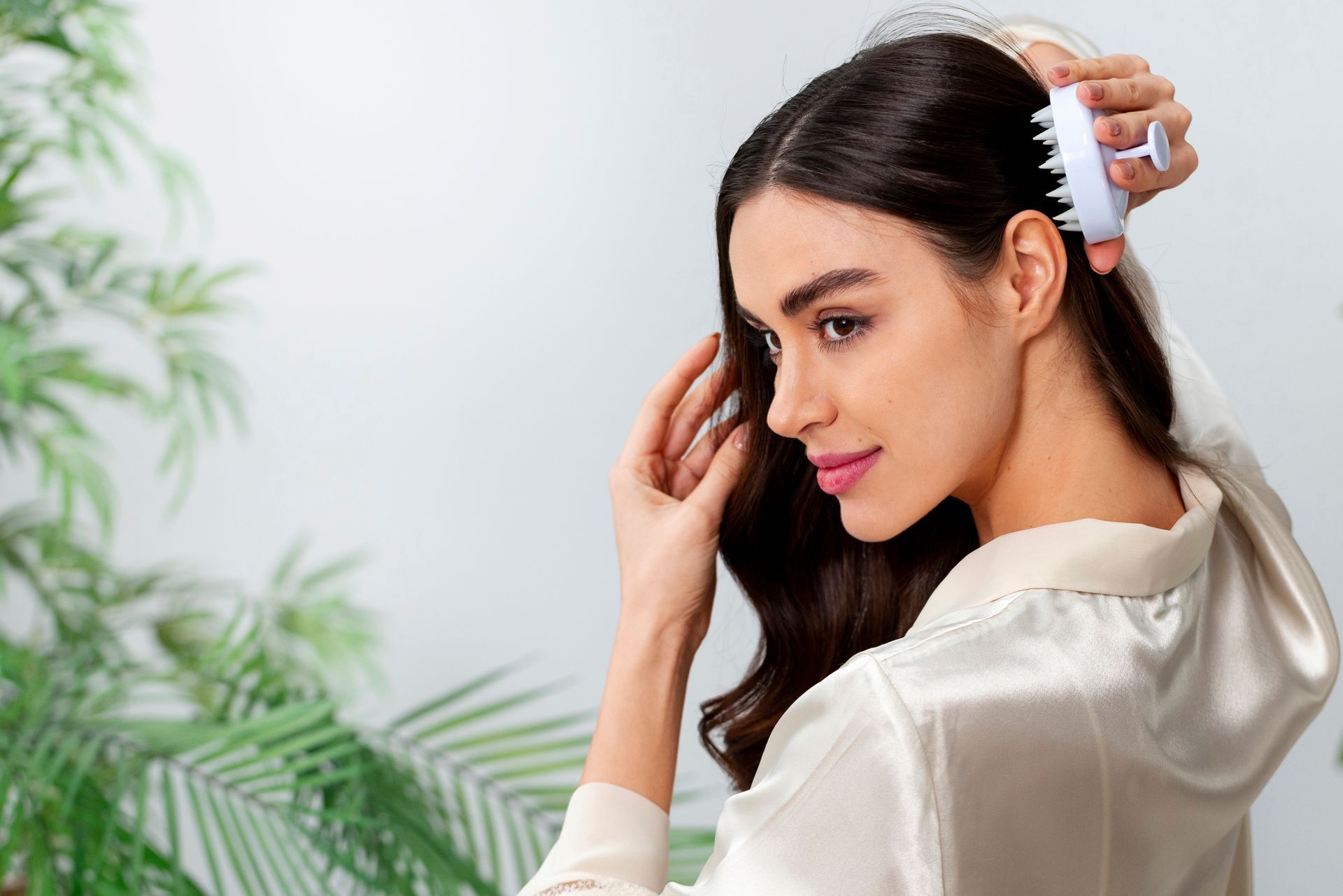 A woman is brushing her hair with a comb.