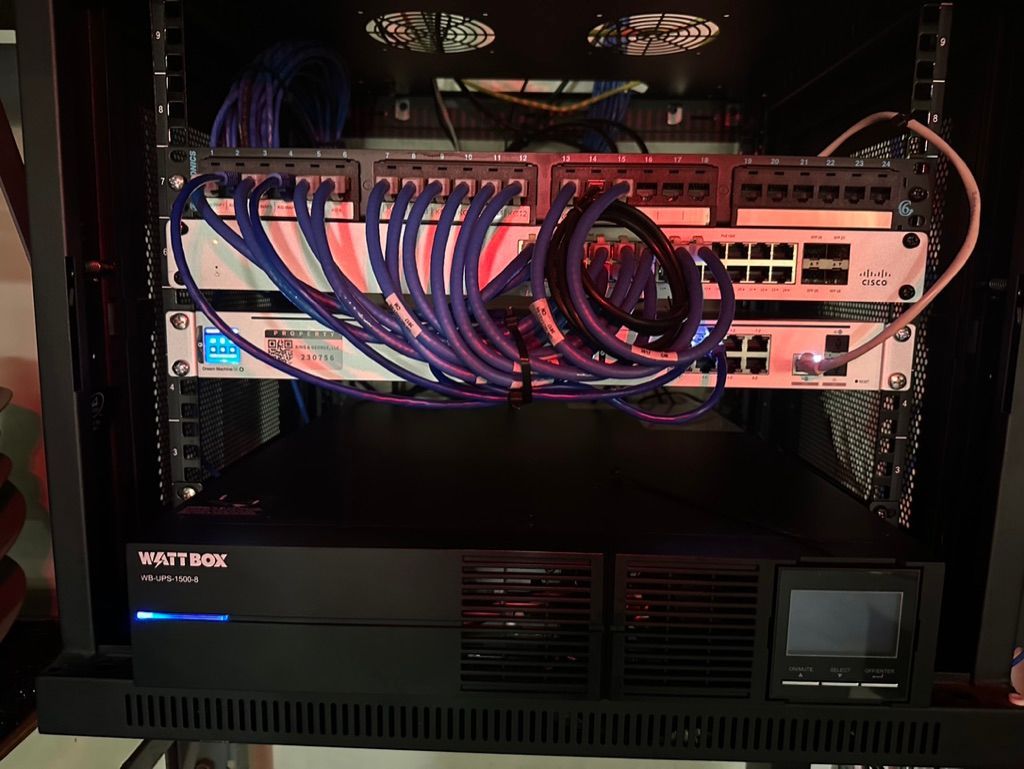 A server rack with a lot of wires coming out of it