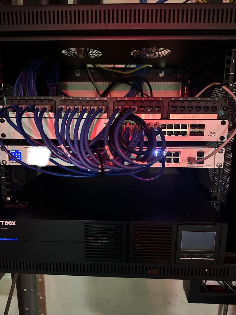 A server rack with a lot of wires coming out of it