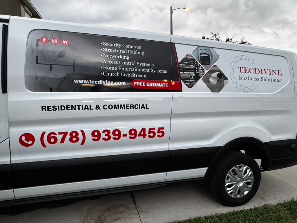 A white van is parked on the side of the road.