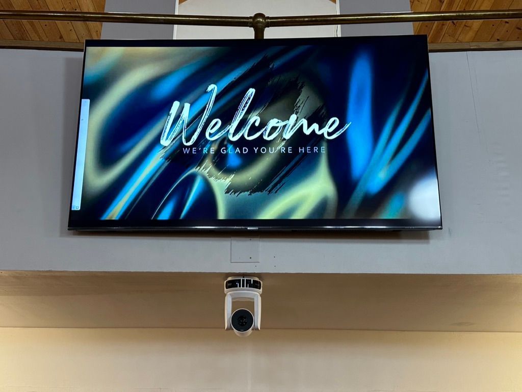 A large screen with the word welcome on it