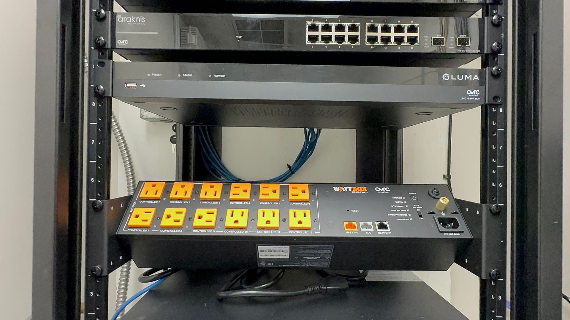 A server rack with a bunch of electrical equipment on it.