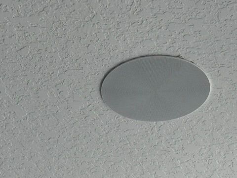 A pair of speakers sitting on top of a plastic bag