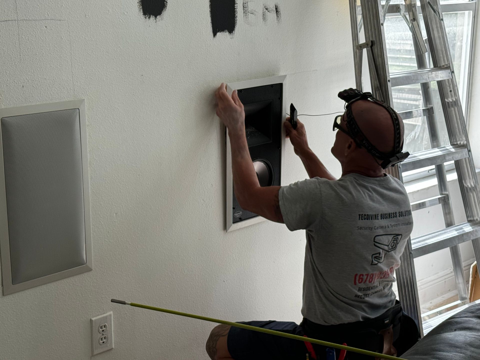 A man is measuring a wall with a tape measure