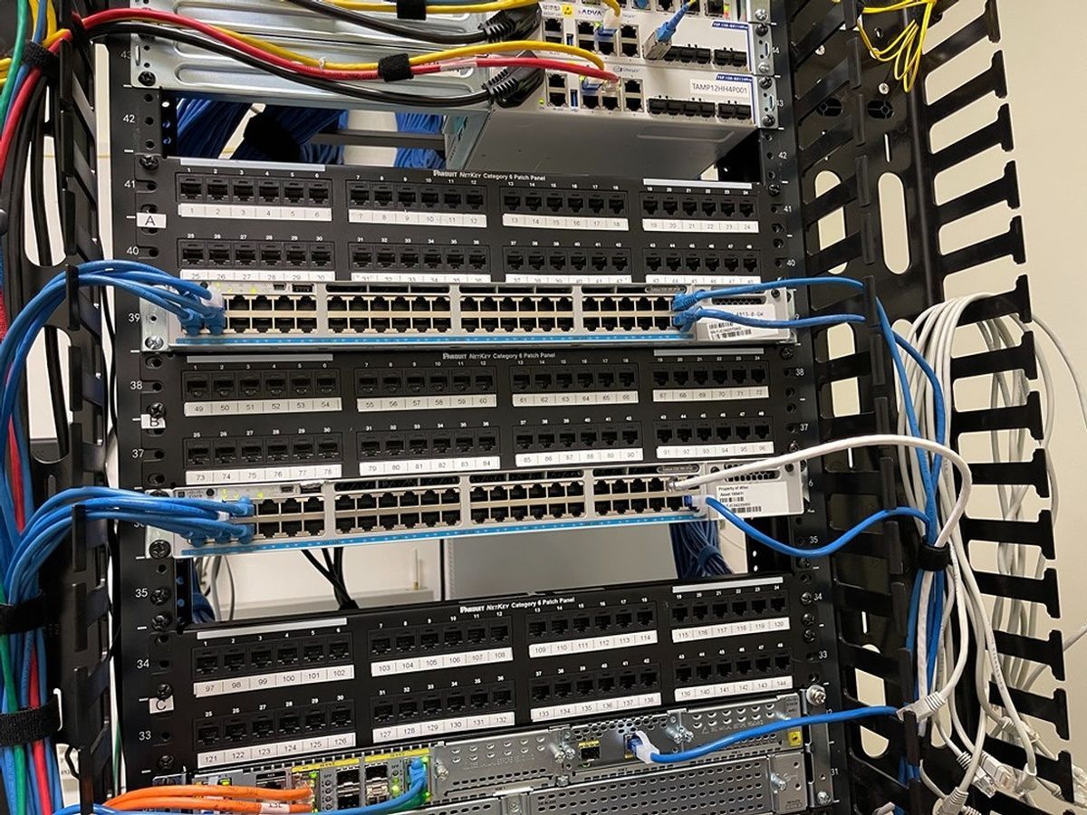 A server rack filled with lots of wires and cables.