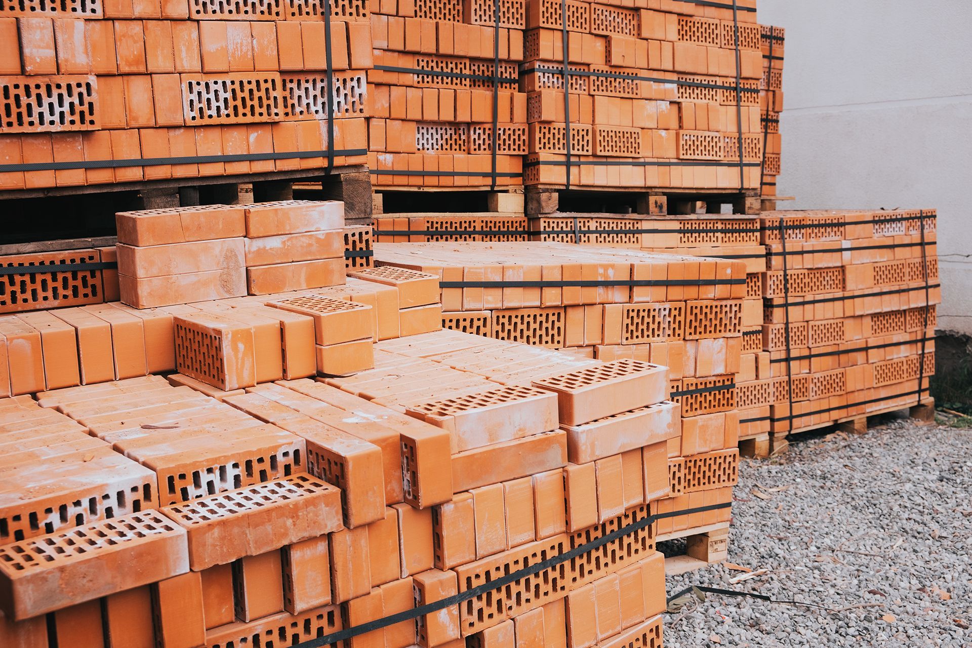 A bunch of bricks are stacked on top of each other on pallets.