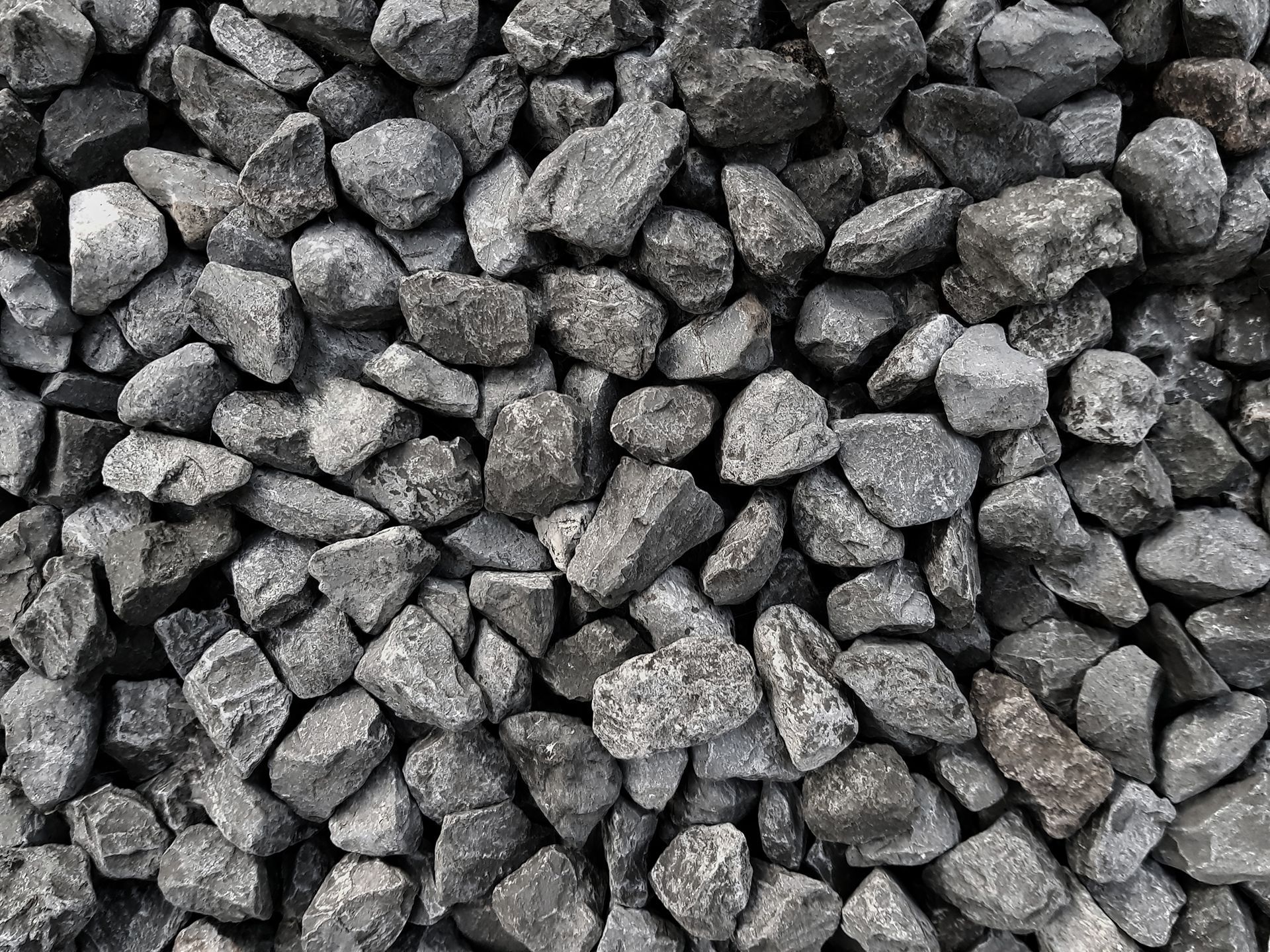 A pile of black rocks sitting on top of each other.