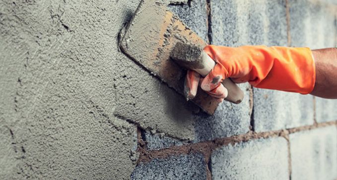 rehabilitación de fachada con enfoscado de cemento en Huelva