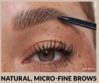 Close-up of eye with defined, natural-looking brows being enhanced with a black brow pencil.