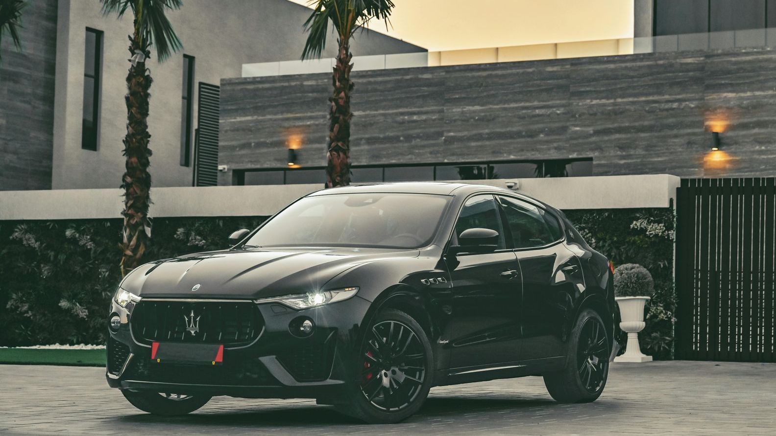 A white mercedes benz amg gt63 s is parked in a garage.
