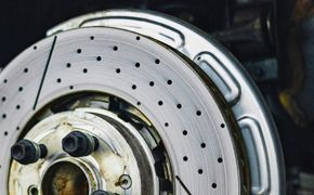 A close up of a brake disc on a car.