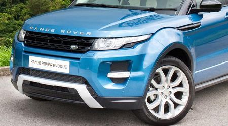 a white range rover is parked in a parking lot