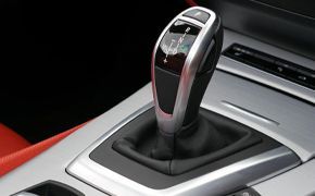 A close up of a car 's shifter and controls