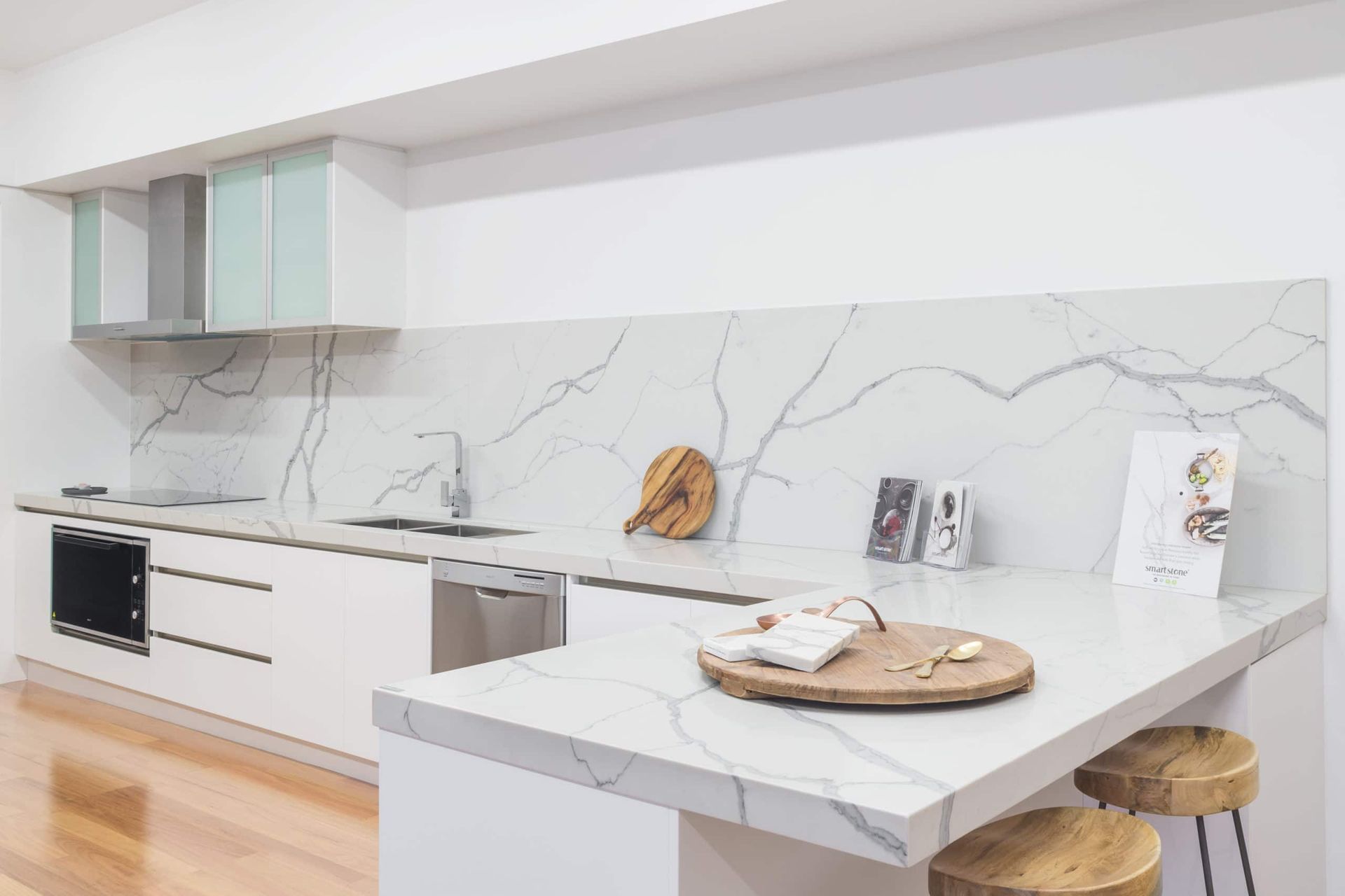 Modern White Kitchen With Marble Countertop and Backsplash, Wooden Stools — Akyrah Kitchens in Gympie, QLD