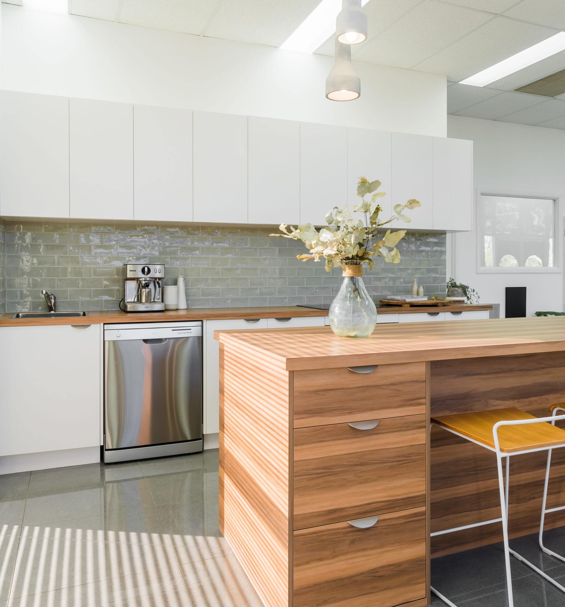 Kitchen With White Cabinets, Stainless Steel Appliances, and a Wooden Island With Bar Stools — Akyrah Kitchens in Gympie, QLD