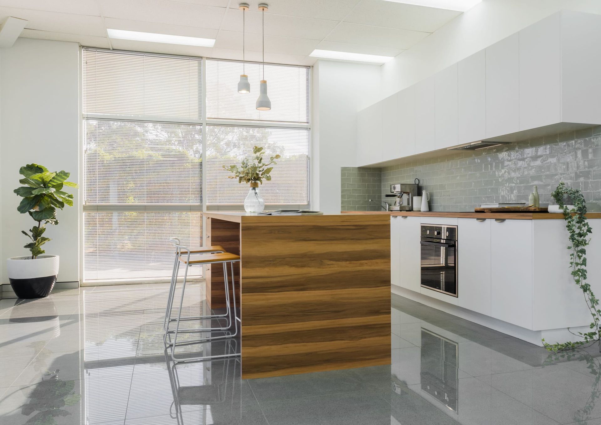 Modern Kitchen With Large Window, Wooden Island, White Cabinets, and Potted Plant — Akyrah Kitchens in Gympie, QLD