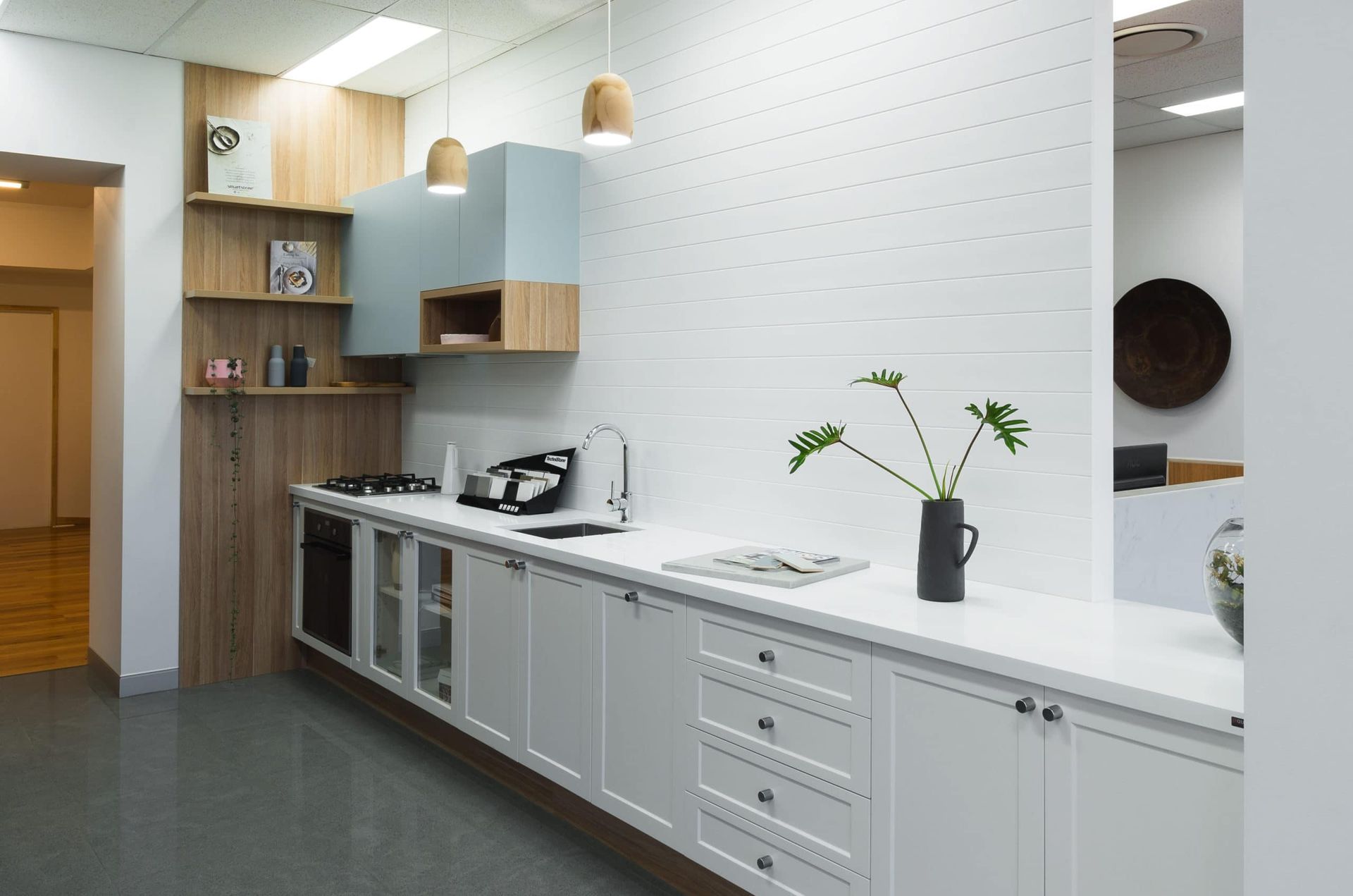 Modern Office Kitchenette With White Cabinets, Light Wood Accents, and a Gray Floor — Akyrah Kitchens in Gympie, QLD
