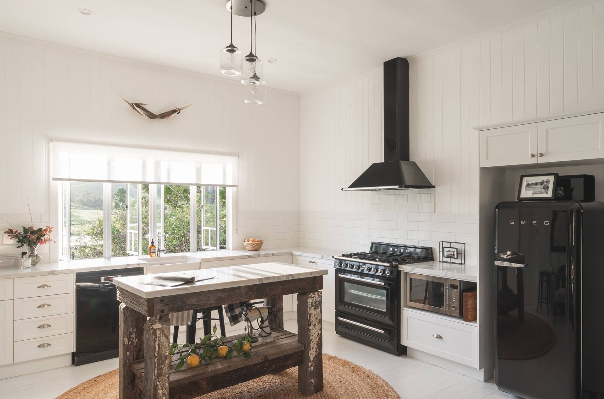 Modern Kitchen With White Cabinets, Gray Countertops, and Wood Island With Bar Stools — Akyrah Kitchens in Gympie, QLD