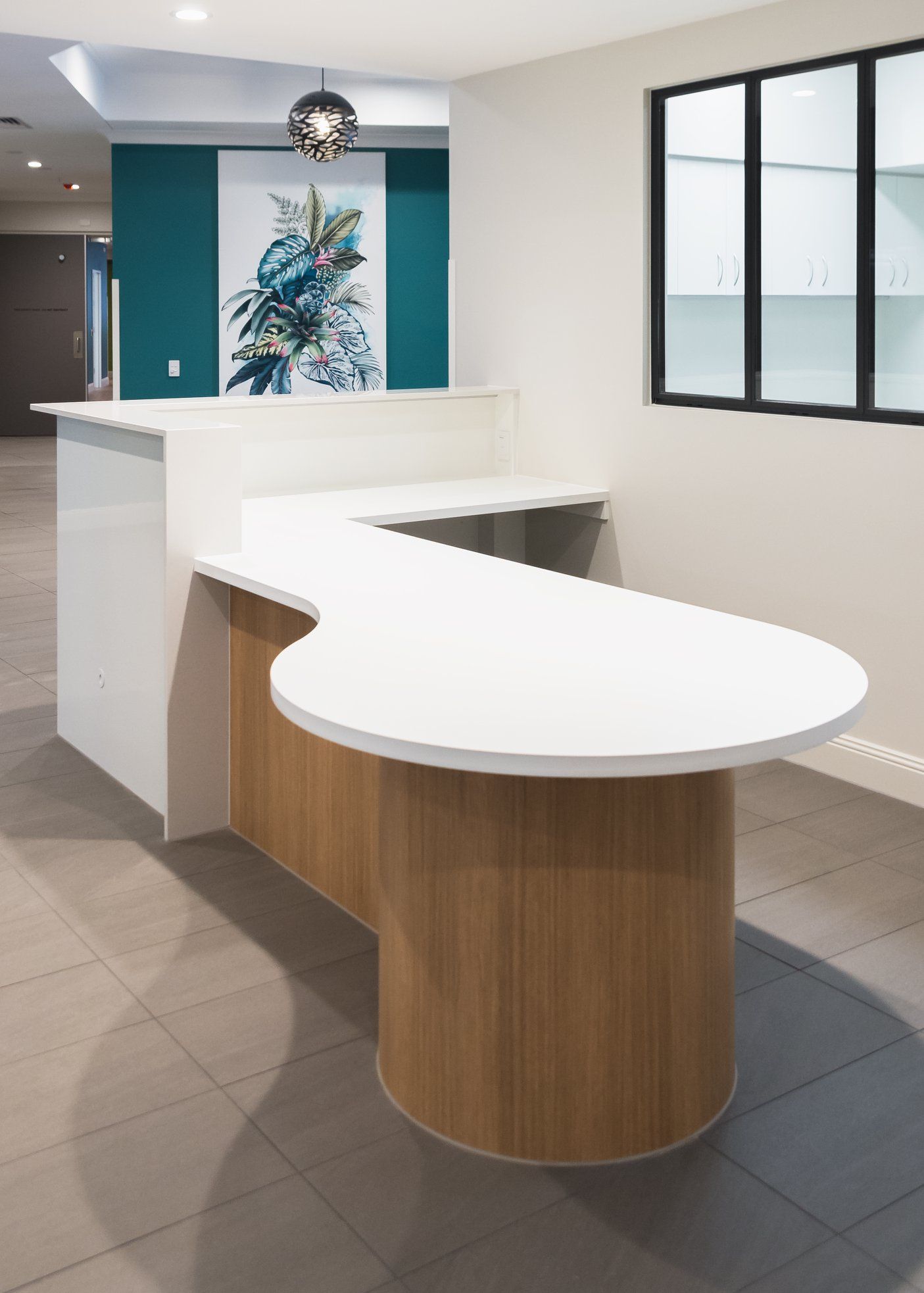 Reception Desk in a Modern Office With a White Countertop and Wood-paneled Base — Akyrah Kitchens in Gympie, QLD