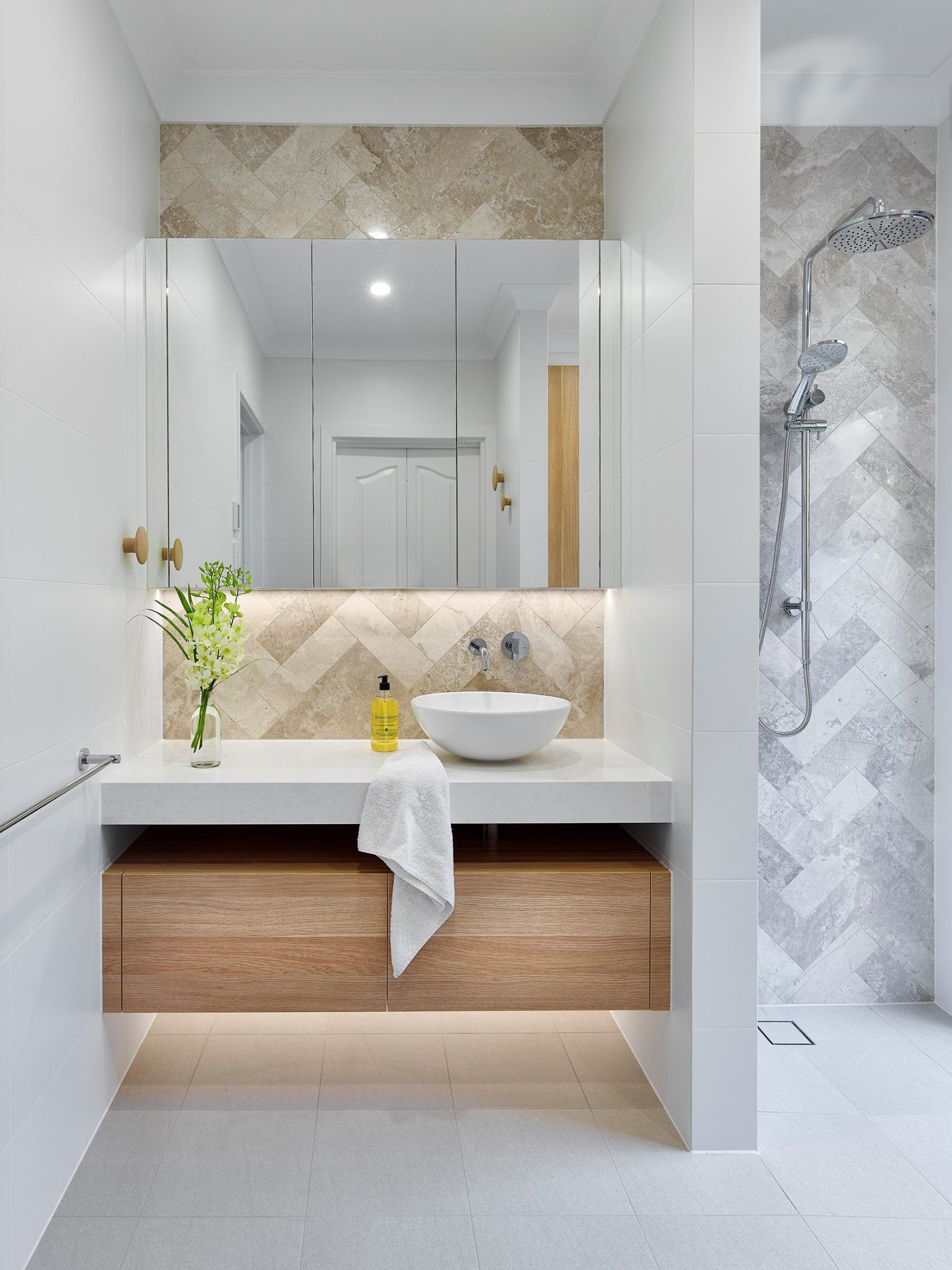 Modern Bathroom With a Wood Vanity, White Sink, and Herringbone Tile Shower — Akyrah Kitchens in Gympie, QLD