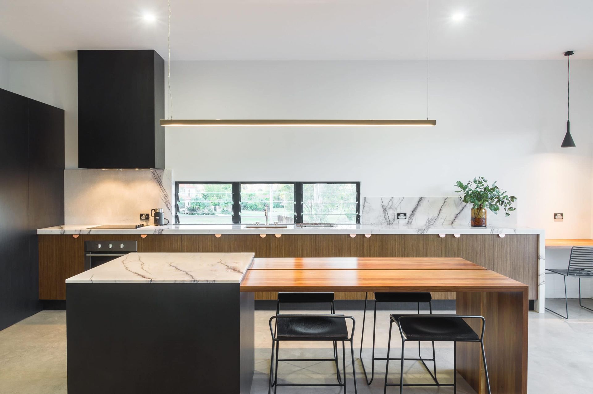 Modern Kitchen With Marble Countertops, Wooden Cabinetry, and Black Accents — Akyrah Kitchens in Gympie, QLD