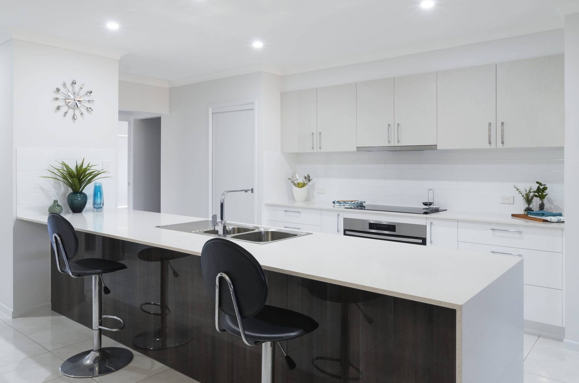 Modern Kitchen With White Countertops, Dark Island, and Two Black Bar Stools — Akyrah Kitchens in Gympie, QLD