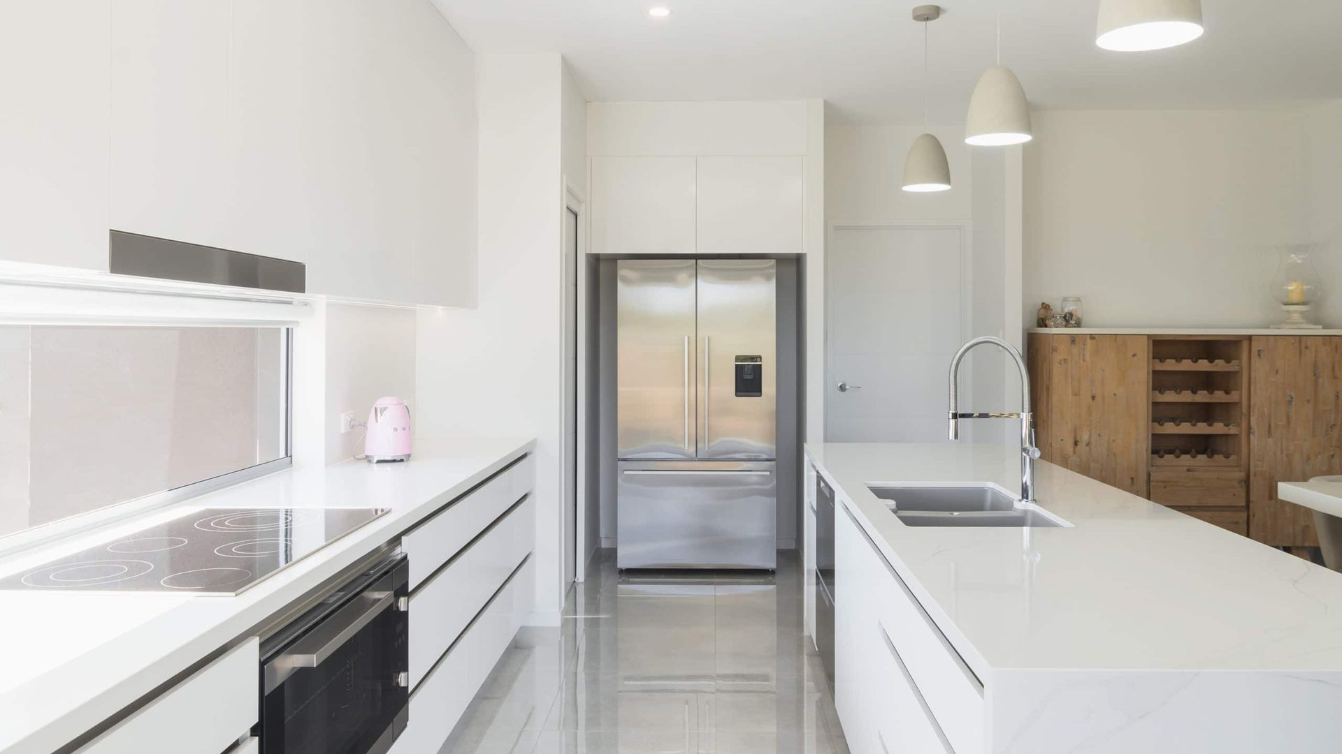 Modern White Kitchen With Stainless Steel Refrigerator, White Countertops, and Wood Cabinets — Akyrah Kitchens in Gympie, QLD