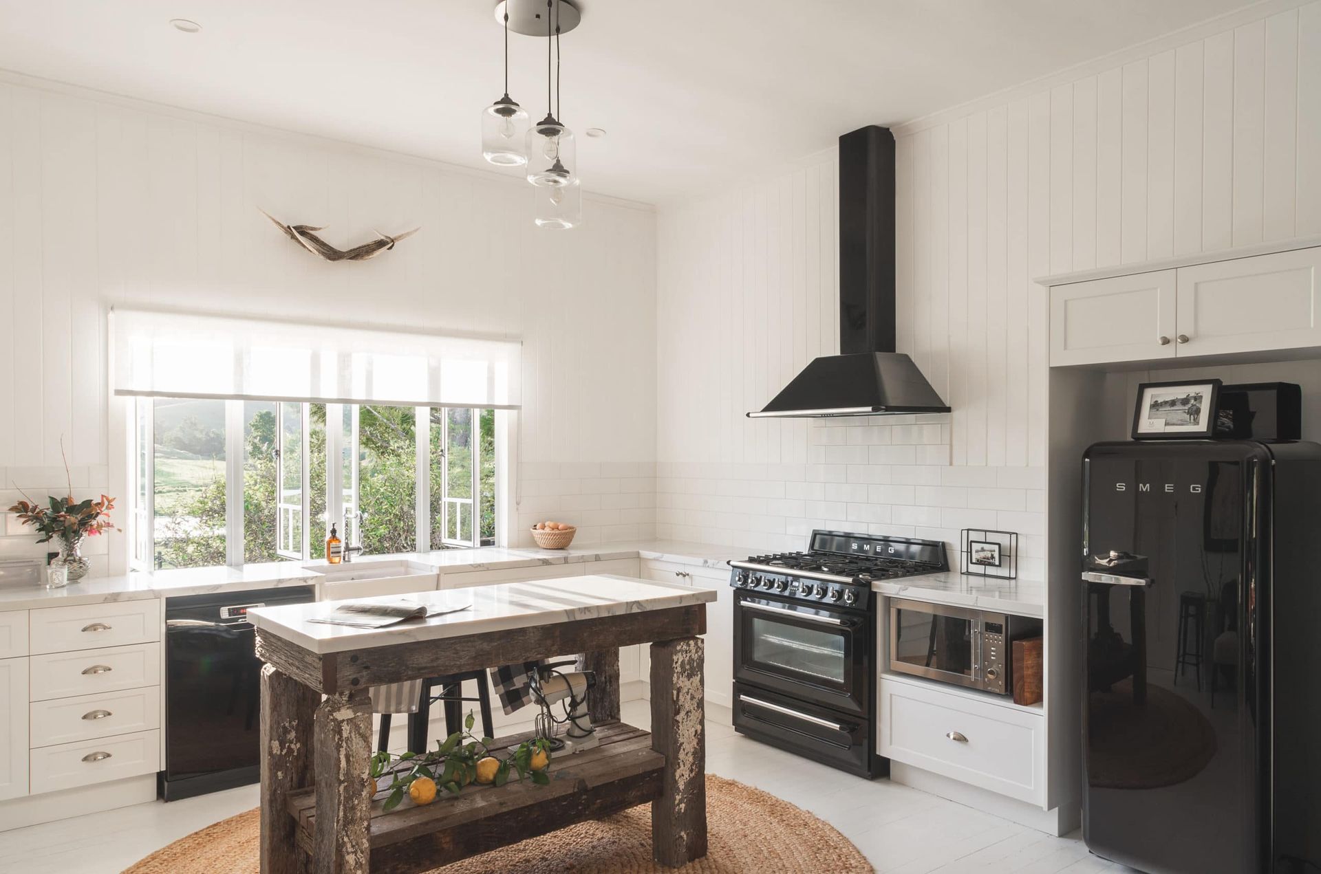 Kitchen With Black Appliances, a Rustic Wooden Island, and a Window Overlooking a Landscape — Akyrah Kitchens in Gympie, QLD