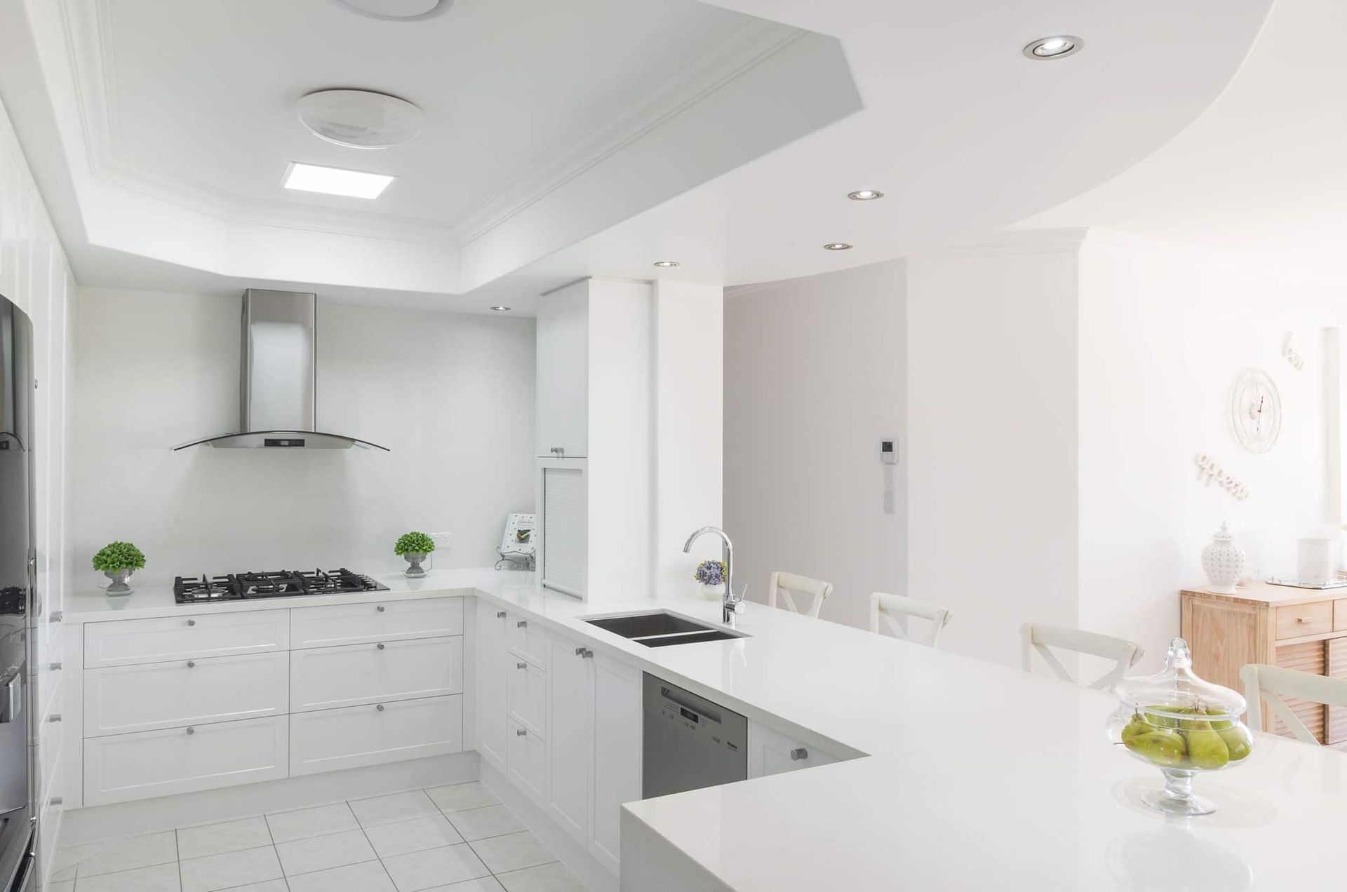White Kitchen With Counter, Stainless Steel Range Hood, and Tile Floor — Akyrah Kitchens in Gympie, QLD