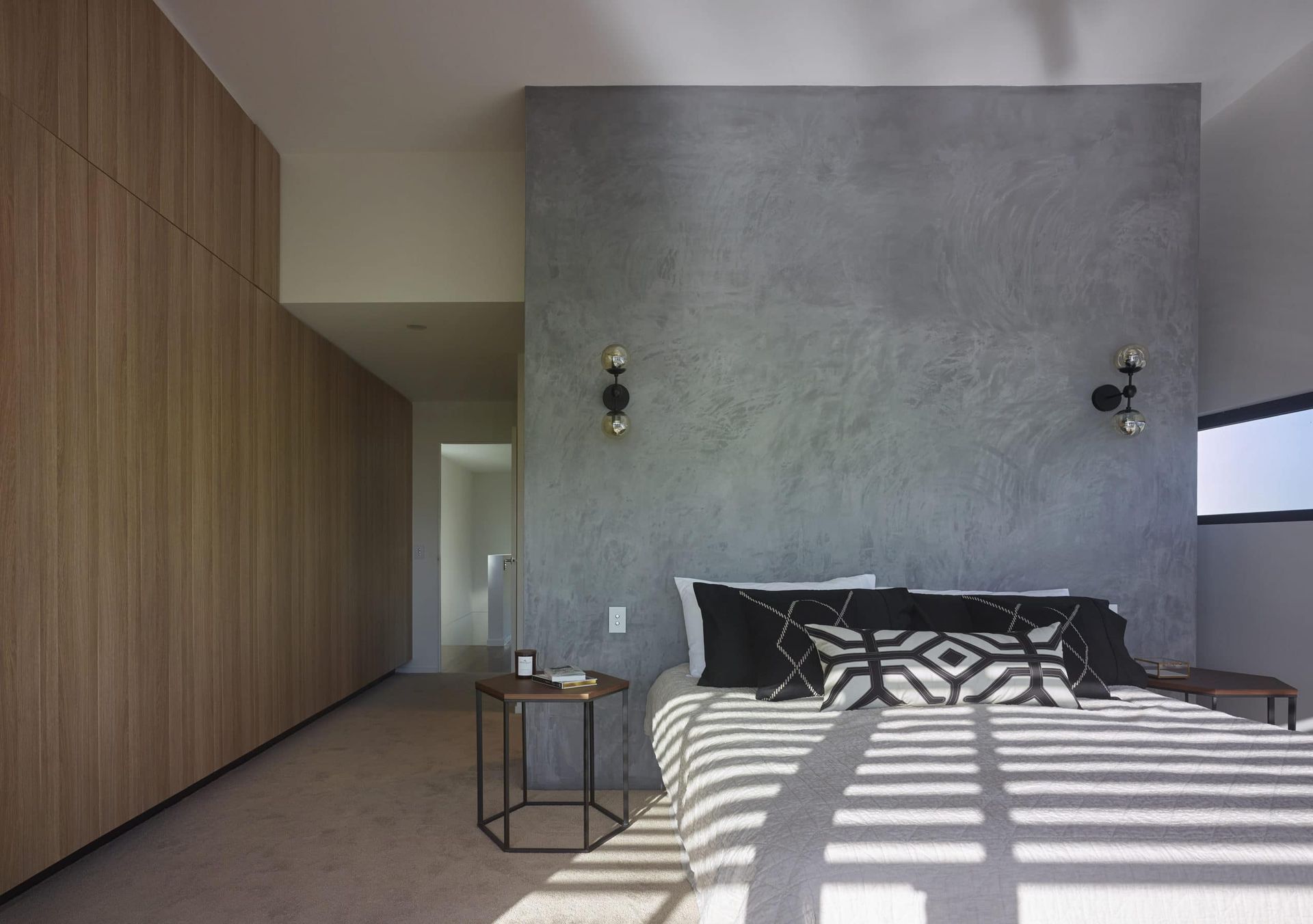 Bedroom With Gray Textured Wall Behind Bed, Wooden Closet to the Left, Side Table — Akyrah Kitchens in Gympie, QLD