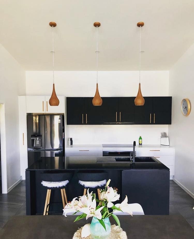 Modern Kitchen With Black Island, White Counters, and Three Wooden Pendant Lights — Akyrah Kitchens in Gympie, QLD