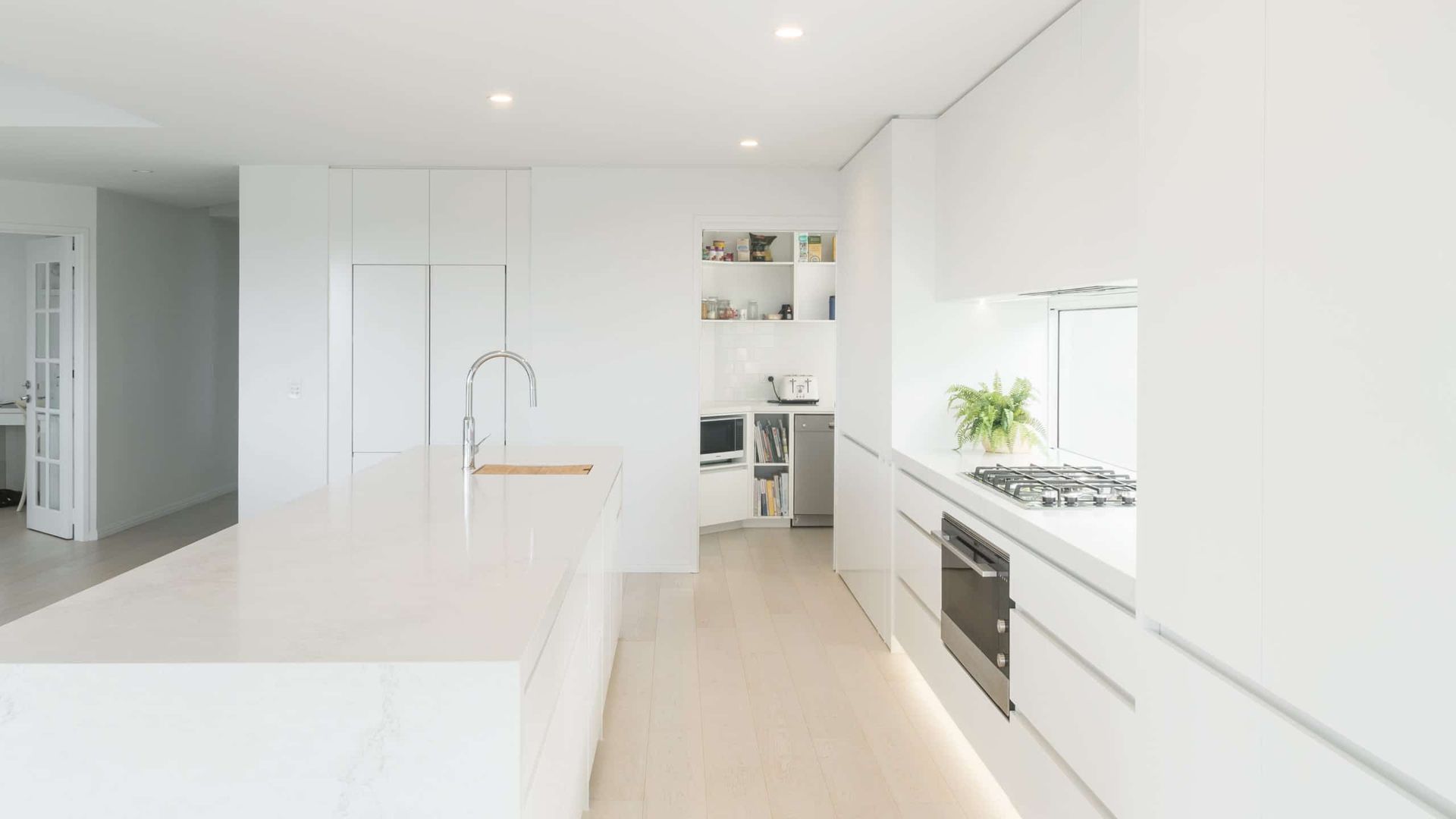 Modern White Kitchen With Island, Cabinets, and Appliances — Akyrah Kitchens in Gympie, QLD